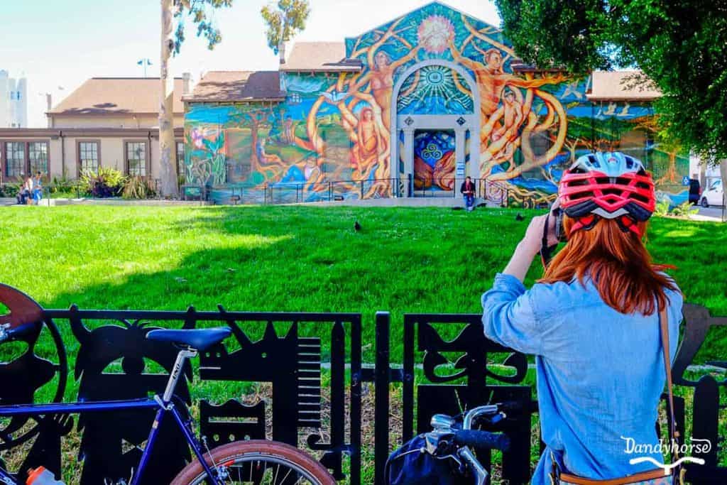 Bike tour group immersing in the vibrant mural culture of San Francisco's Mission District